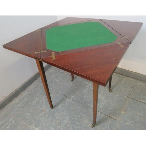 867 - An Edwardian mahogany envelope card table, crossbanded and strung with boxwood and ebony, housing on... 