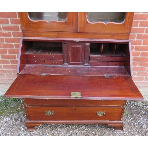 877 - A Georgian mahogany bureau bookcase, the top section with two height-adjustable shelves above three ... 