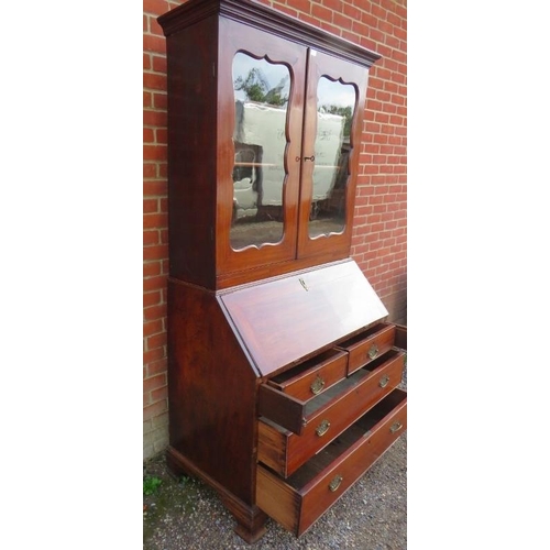 877 - A Georgian mahogany bureau bookcase, the top section with two height-adjustable shelves above three ... 