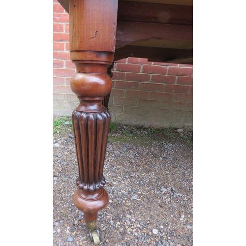 880 - A large Victorian mahogany draw-leaf extending dining table, with three additional leaves, on taperi... 