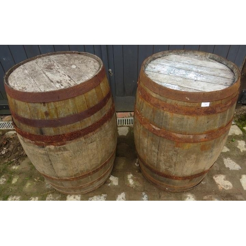 886 - Two antique oak and iron coopered whisky barrels/garden tables. 
H89cm Diameter 59cm (approx).
Condi... 