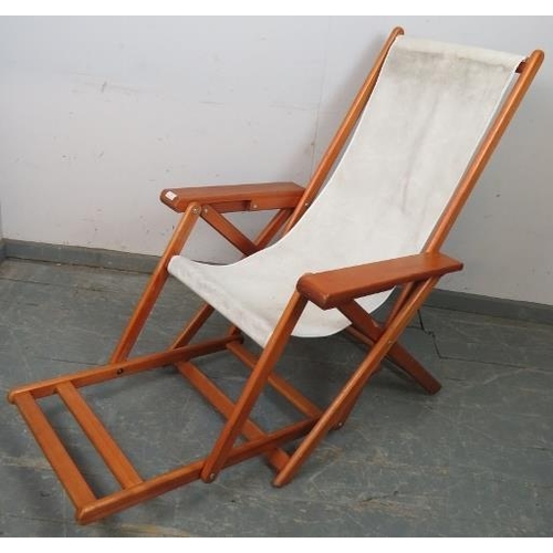 890 - A mid-century plantation style teak folding sun lounger, with footrest. 
H103 W69 D122 (unfolded)
Co... 