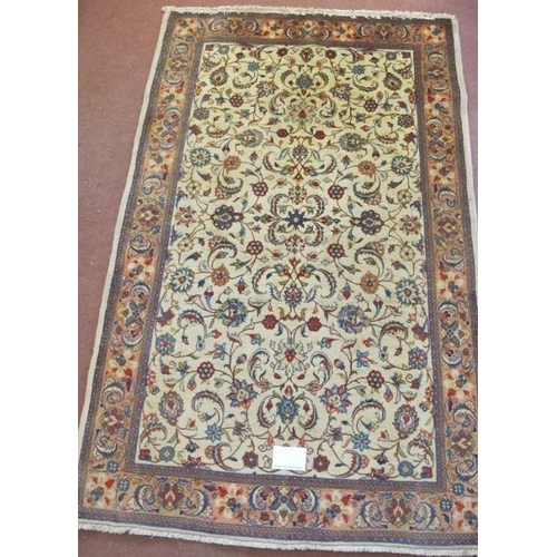 912 - A central Persian Sarouk rug with central floral pattern on cream ground. 210cm x 130cm. Very clean ... 