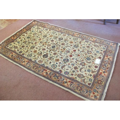 912 - A central Persian Sarouk rug with central floral pattern on cream ground. 210cm x 130cm. Very clean ... 