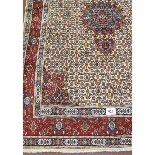 923 - A good Persian Mood carpet with central motif on a cream and tan ground, highlighted in terracotta. ... 