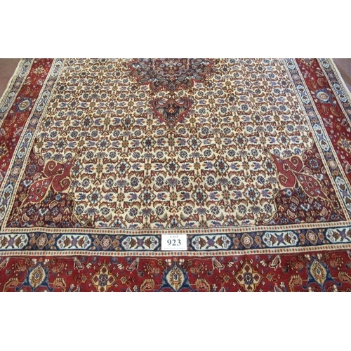 923 - A good Persian Mood carpet with central motif on a cream and tan ground, highlighted in terracotta. ... 