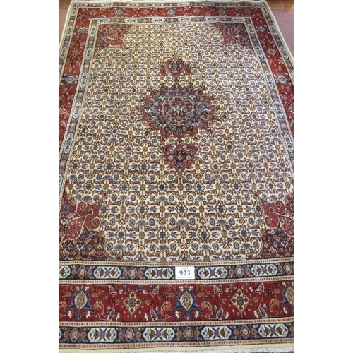 923 - A good Persian Mood carpet with central motif on a cream and tan ground, highlighted in terracotta. ... 