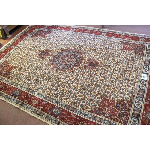 923 - A good Persian Mood carpet with central motif on a cream and tan ground, highlighted in terracotta. ... 