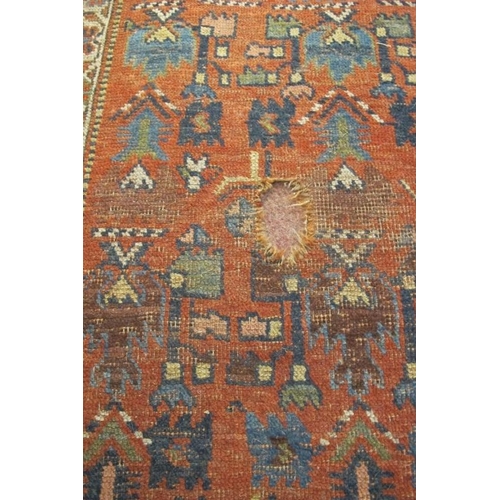 927 - An early-mid 20th century Persian rug - shabby chic look. Some wear to edging and repair needed to c... 