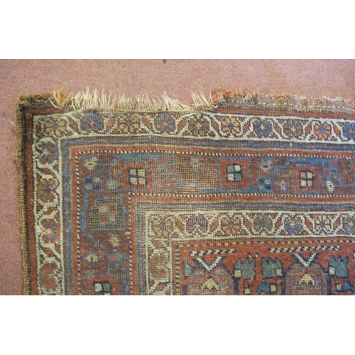 927 - An early-mid 20th century Persian rug - shabby chic look. Some wear to edging and repair needed to c... 