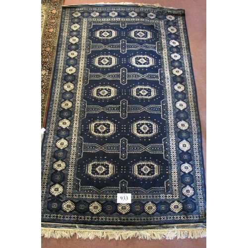 933 - A 20th century Persian rug deep blue with a cream repeat pattern. 225cm x 127cm.