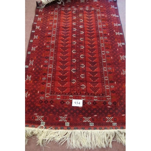 934 - A 20th century rug central repeat pattern n red ground. Very clean rug. 230cm max x 124cm.