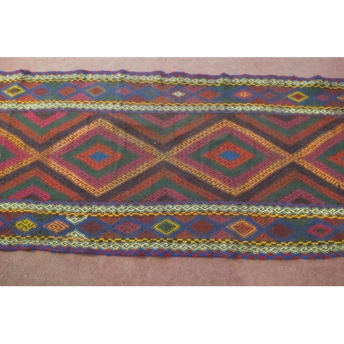 938 - A 20th century Kilim rug, colourful, central diamond motifs and in good condition. 250cm x 80cm.