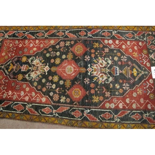 943 - A fine mid 20th century Baluch rug with stylized floral motifs on claret 4 charcoal field. 1.72cm x ... 