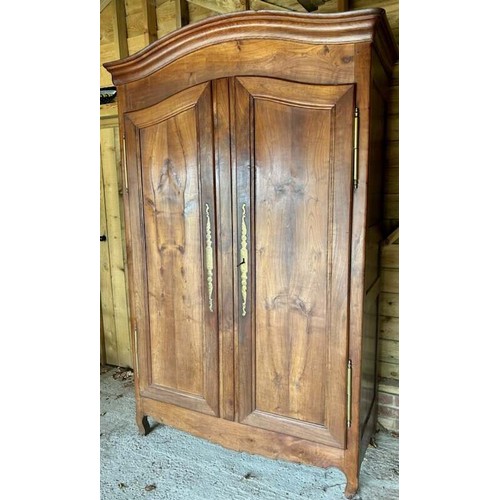 713 - An 18th century French fruitwood armoire of good colour, with polished brass hinges and lock escutch... 