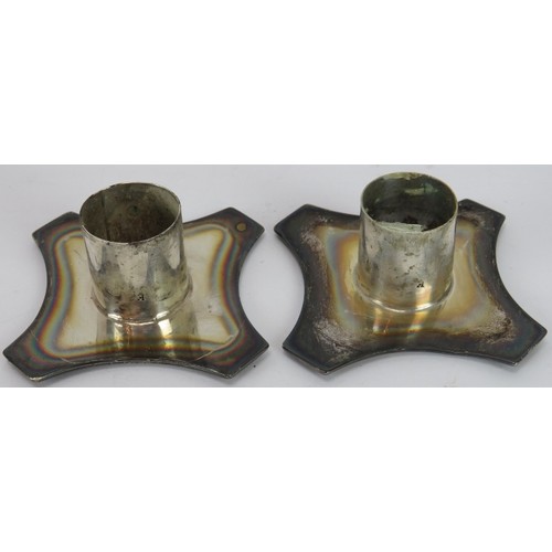 372 - A pair of Art Nouveau silver candlesticks on square bases and decorated with bows and swags. Approx ... 