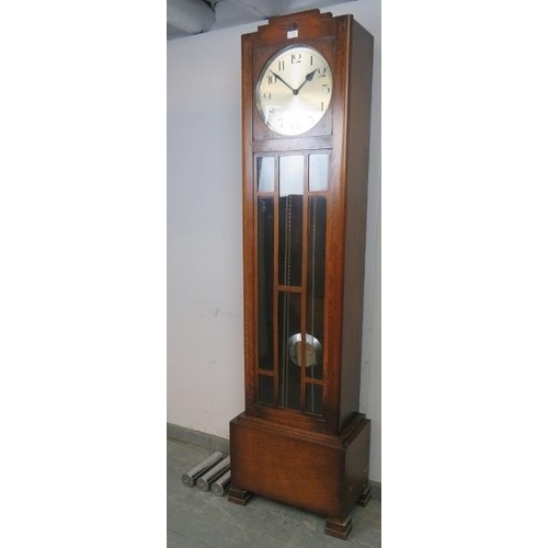 725 - An Art Deco Period oak cased Westminster chiming longcase clock, having a three weight driven moveme... 