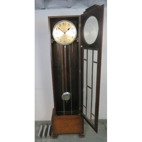 725 - An Art Deco Period oak cased Westminster chiming longcase clock, having a three weight driven moveme... 