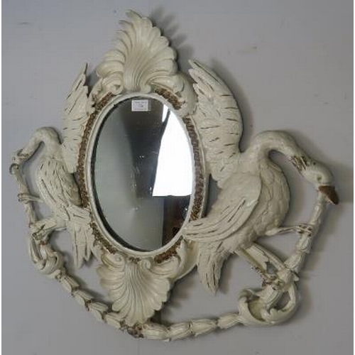 726 - An 18th century Georgian oval mirror, within an ornately carved wooden surround having a shell corni... 