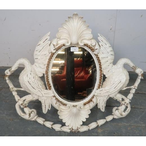 726 - An 18th century Georgian oval mirror, within an ornately carved wooden surround having a shell corni... 