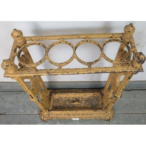 784 - An early 20th century cast iron umbrella stand in the manner of Coalbrookdale, painted ochre, the fi... 