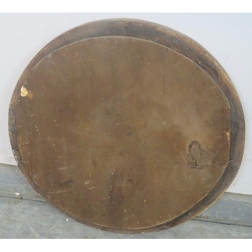 844 - A turn of the century circular bevelled wall mirror, within a stripped oak frame with beaded red acc... 
