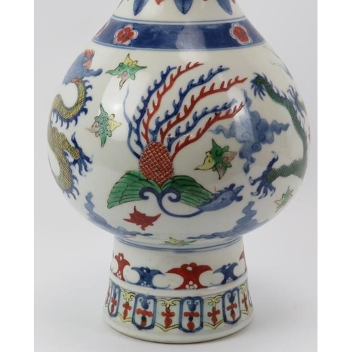 10 - A Chinese Wucai decorated porcelain vase, 20th century. Of pear shaped form with a flared cylindrica... 