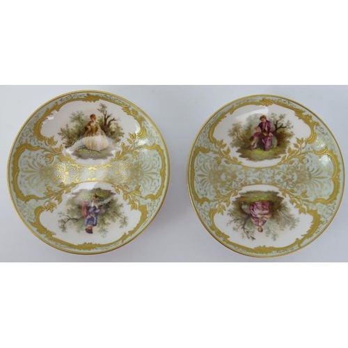 101 - A pair of KPM Berlin gilt and polychrome painted porcelain teacups and saucers, 19th century. Both f... 