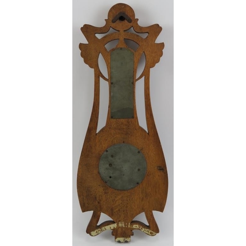 124 - An Art Nouveau carved oak barometer, early 20th century. Incorporated with a mercury thermometer. 48... 