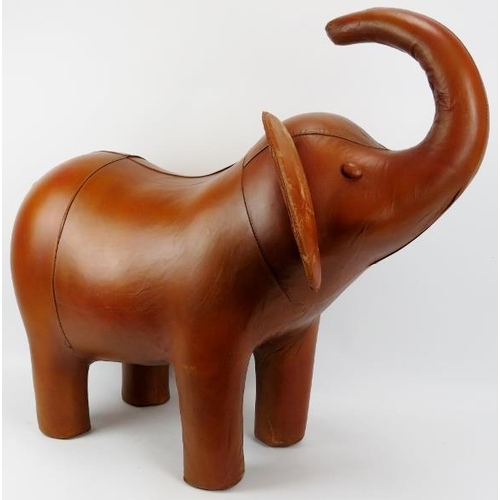 134 - A large vintage hand made hazelnut brown leather elephant footstool. Modelled with flappy ears and t... 