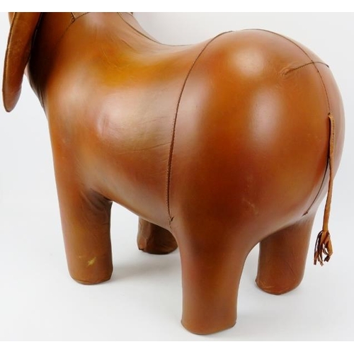 134 - A large vintage hand made hazelnut brown leather elephant footstool. Modelled with flappy ears and t... 