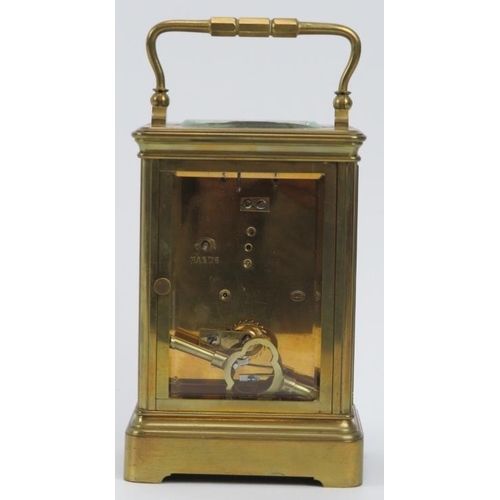 154 - A French gilt brass cased carriage clock retailed by J W Benson of London. With an enamelled white d... 