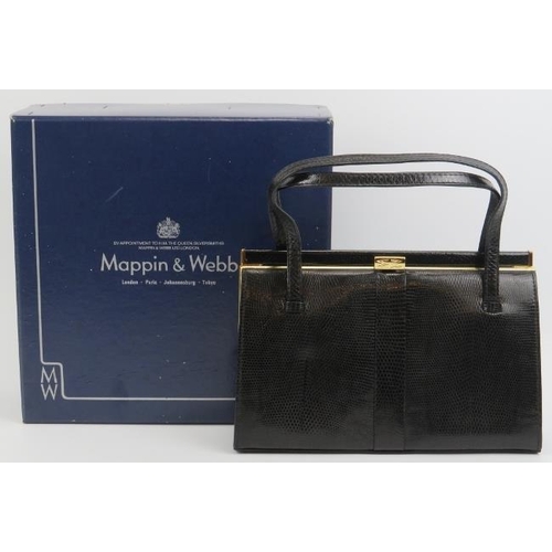 23 - A Mappin & Webb black lizard skin handbag. With gilt metal mounts and clasp, the interior with a zip... 