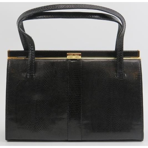 23 - A Mappin & Webb black lizard skin handbag. With gilt metal mounts and clasp, the interior with a zip... 