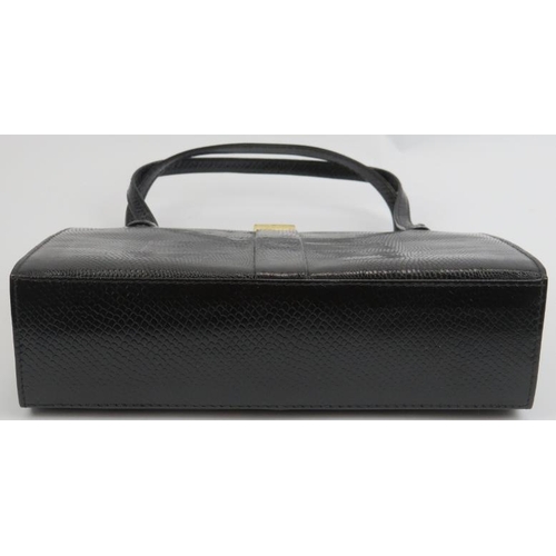 23 - A Mappin & Webb black lizard skin handbag. With gilt metal mounts and clasp, the interior with a zip... 