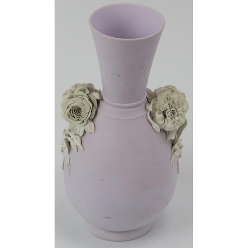 32 - A lilac ground jasperware vase with applied floral decoration in relief. Probably by Wedgwood and th... 