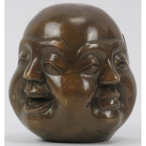 37 - A Chinese bronze four faced Buddha head paperweight, 20th century. Decorated with four contrasting f... 