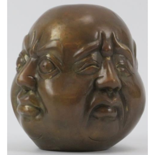 37 - A Chinese bronze four faced Buddha head paperweight, 20th century. Decorated with four contrasting f... 