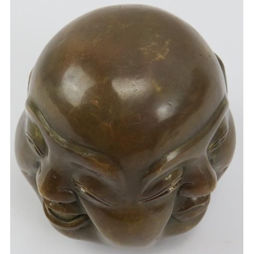 37 - A Chinese bronze four faced Buddha head paperweight, 20th century. Decorated with four contrasting f... 