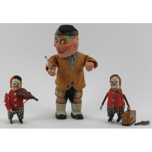 47 - Three vintage clockwork tinplate toy model figures. Comprising a Schuco violin playing clown, a Schu... 