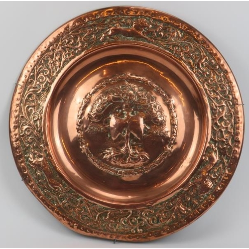 5 - A large embossed copper charger, 19th century. Decorated with the tree of life to the centre inscrib... 