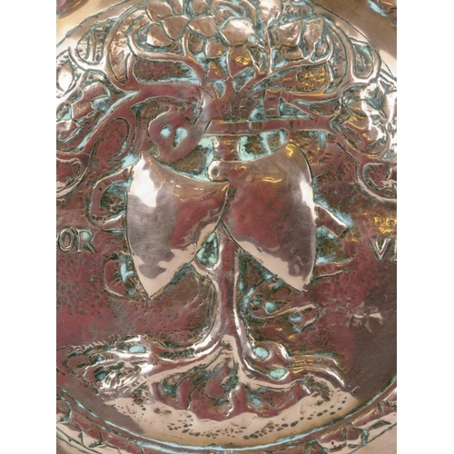 5 - A large embossed copper charger, 19th century. Decorated with the tree of life to the centre inscrib... 