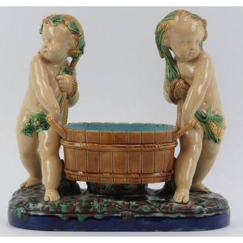 50 - A Minton majolica comport modelled depicting two putti tub basket carriers, 19th century. Impressed ... 