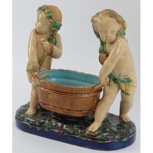 50 - A Minton majolica comport modelled depicting two putti tub basket carriers, 19th century. Impressed ... 