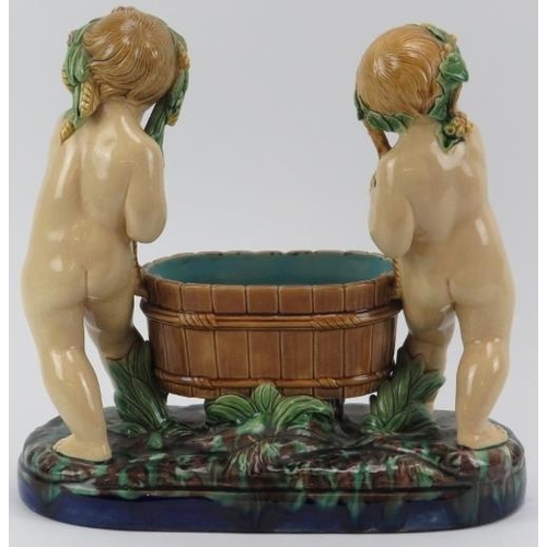 50 - A Minton majolica comport modelled depicting two putti tub basket carriers, 19th century. Impressed ... 