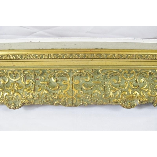 571 - A large late 19th/early 20th century gilt gesso and pine picture frame, relief moulded and swept cla... 