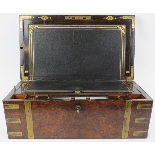 64 - A large Victorian brass bound walnut campaign writing slope. The hinged cover opening to reveal a fi... 