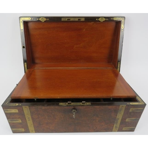 64 - A large Victorian brass bound walnut campaign writing slope. The hinged cover opening to reveal a fi... 