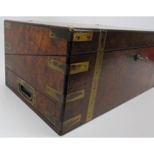 64 - A large Victorian brass bound walnut campaign writing slope. The hinged cover opening to reveal a fi... 