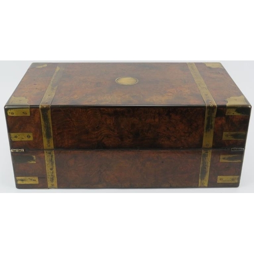 64 - A large Victorian brass bound walnut campaign writing slope. The hinged cover opening to reveal a fi... 